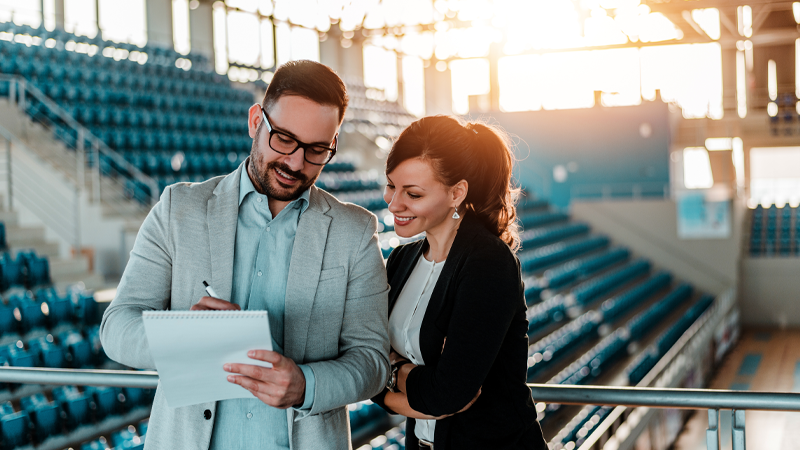 Two business people organizing an event in sport hall