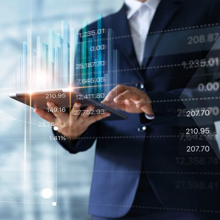 Man working on a tablet with stock prices superimposed on top of the image.