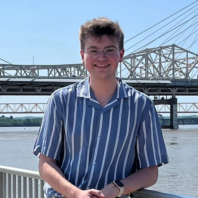 IU Southeast Honors Program student Mitchell Henry posing and smiling in front of the Ohio River