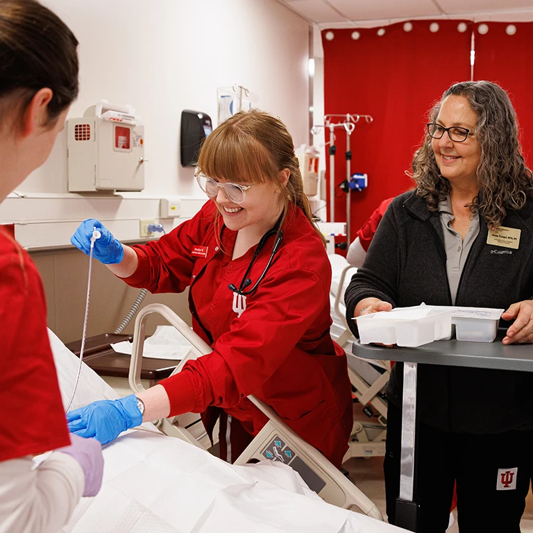 Nursing students practicing in a simulated hospital environment