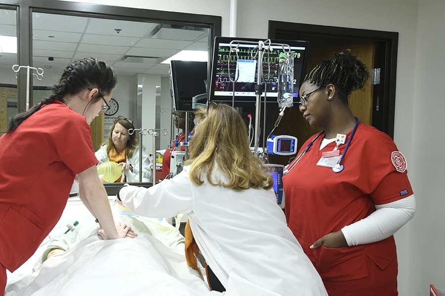 Two IU Southeast nursing students treating an infant patient in a pediatric simulation lab