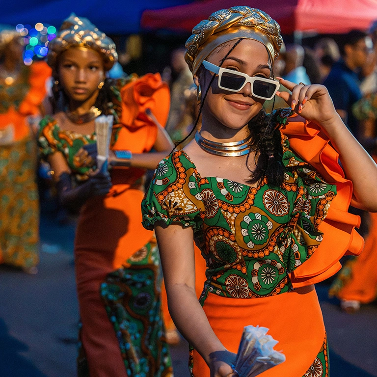 Girls dressed in festival attire walking in a parade