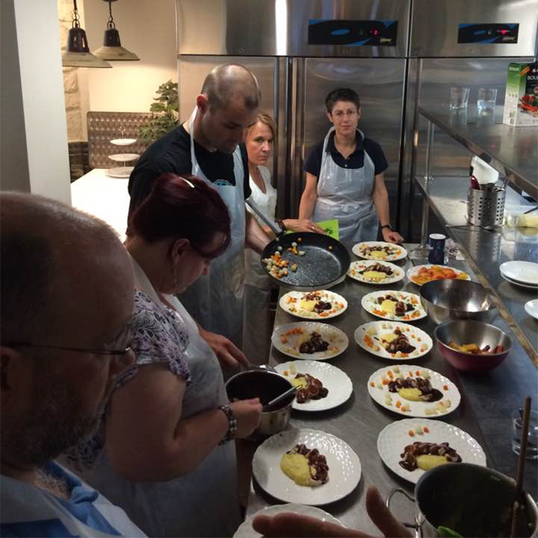 Students and faculty taking a cooking class