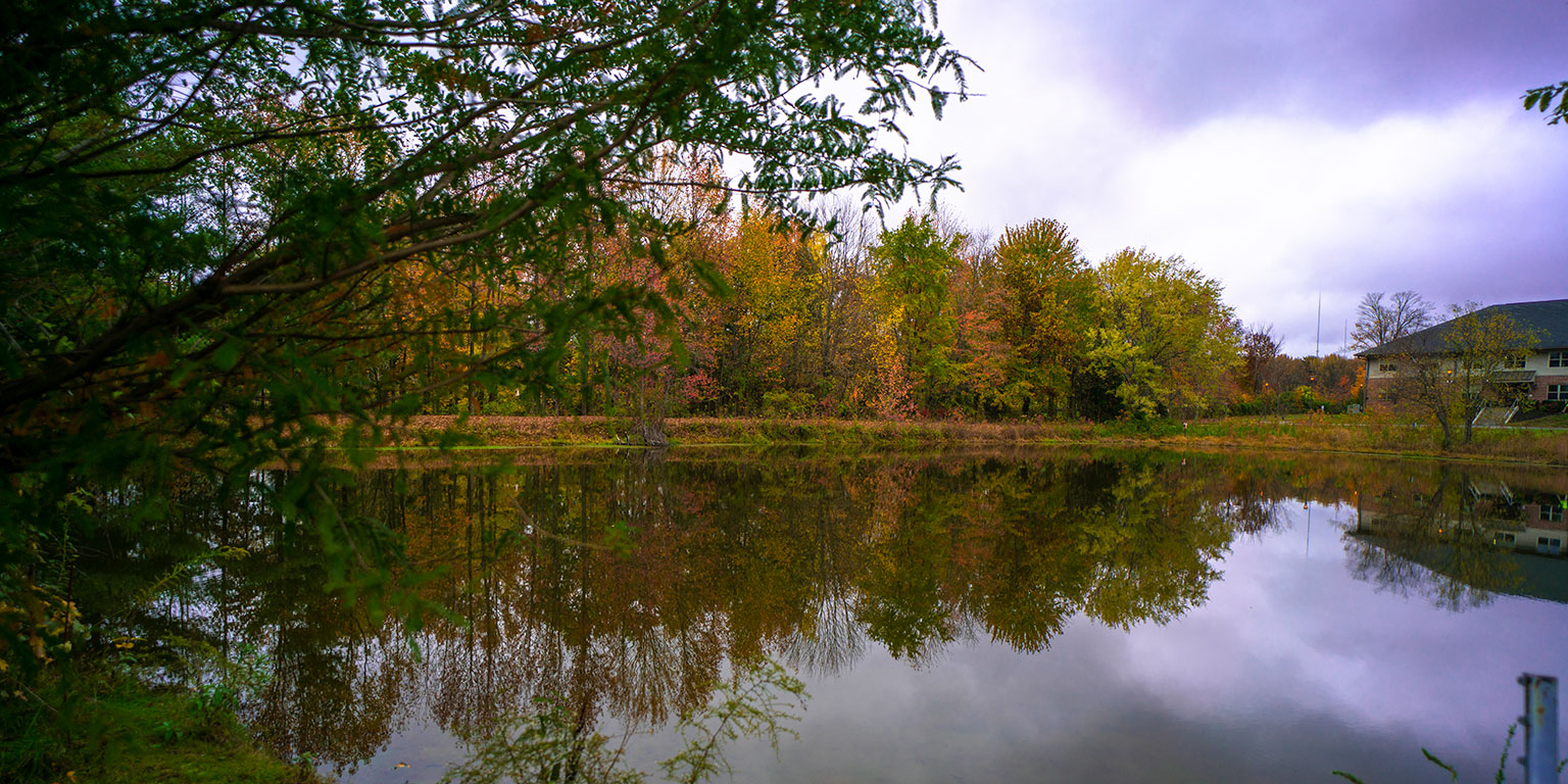 The lake on IU Southeast's campus surrounded by fall foliage